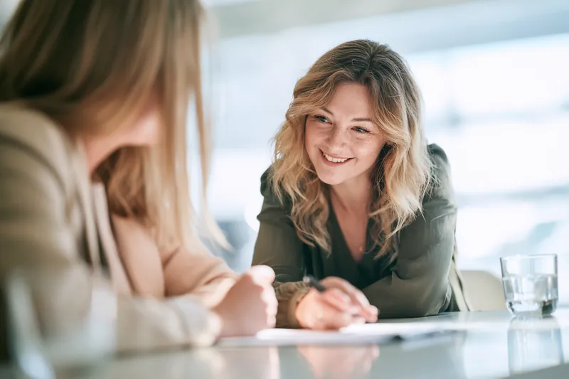American mentor and a younger colleague reviewing finances together